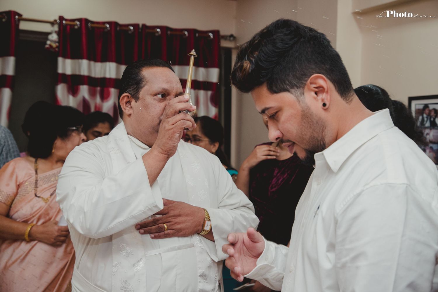 Group of people in white shirts participating in an indoor celebration or gathering.