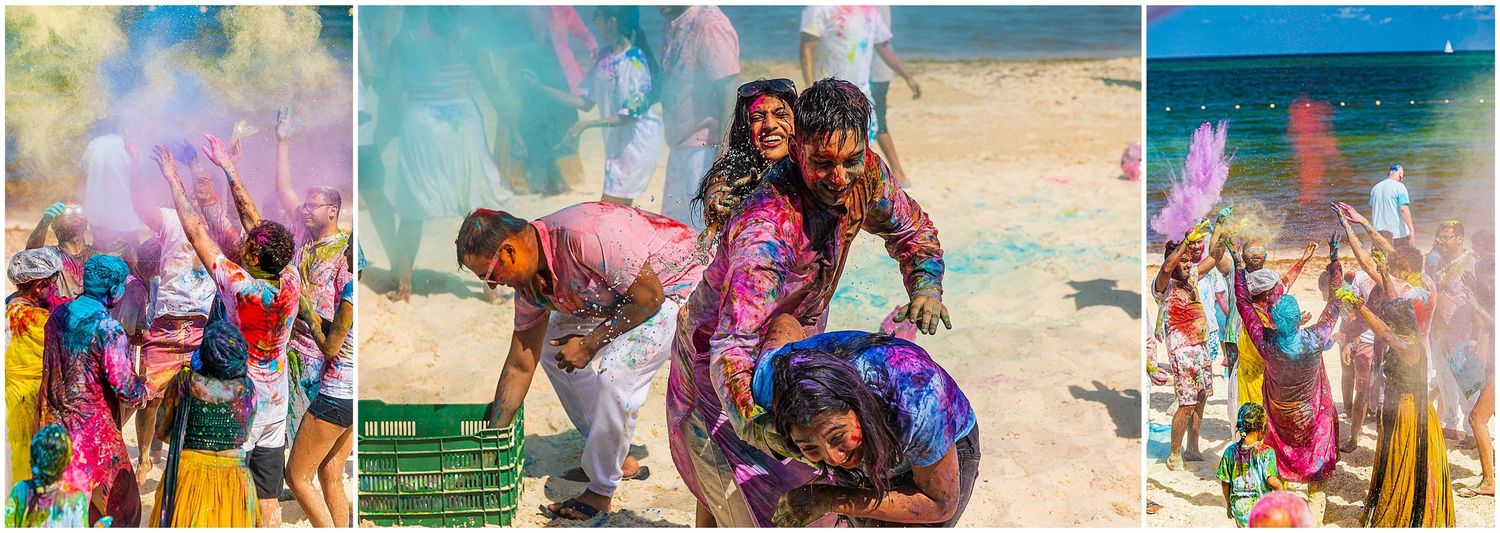 Joyful beach celebration with colorful powder creating festive atmosphere.