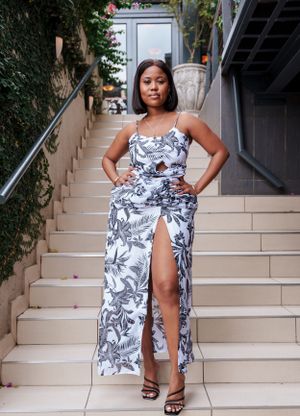 Navy and white floral print dress with thigh-high slit photographed on stone steps.