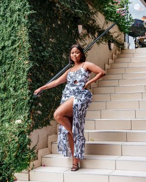 Blue and white floral maxi dress with thigh slit photographed on outdoor stone staircase with ivy.