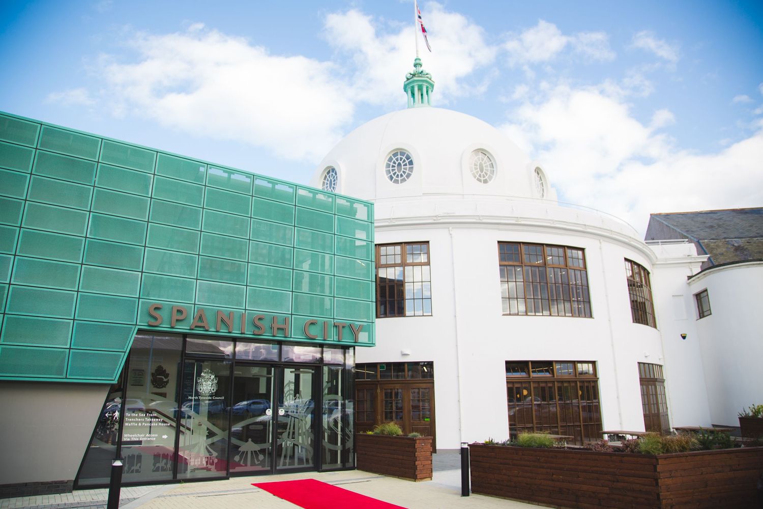 Modern art deco style building exterior with white dome and green facade of Spanish City in Whitley Bay.