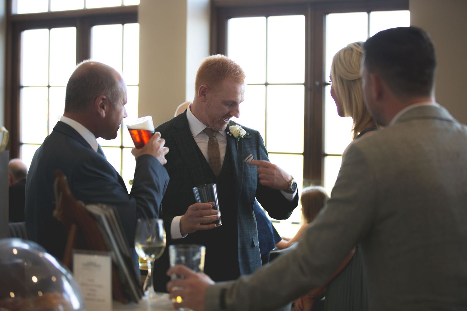 Small group of formally dressed guests chatting at a social gathering.