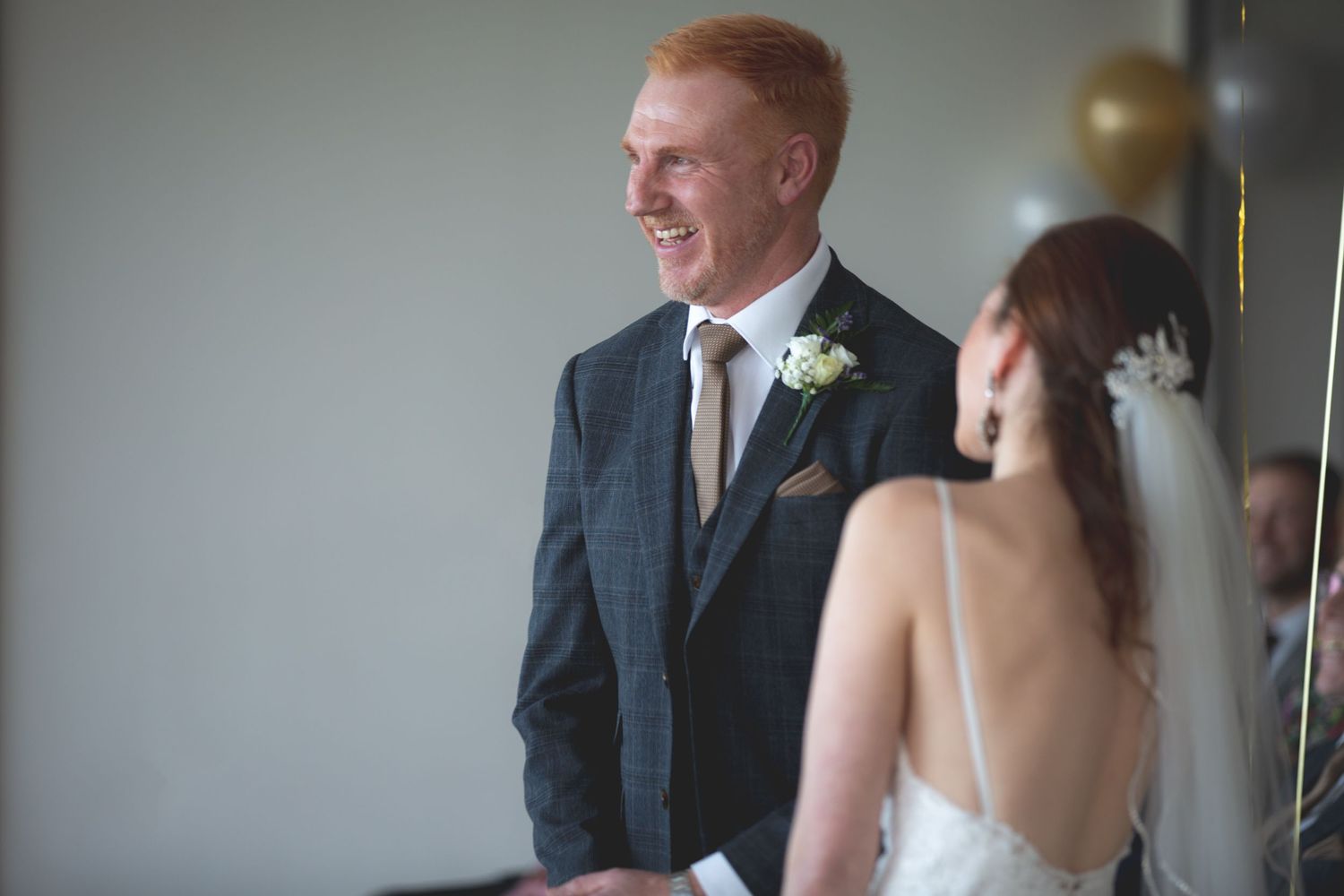 A couple shares a joyful moment during their wedding ceremony.