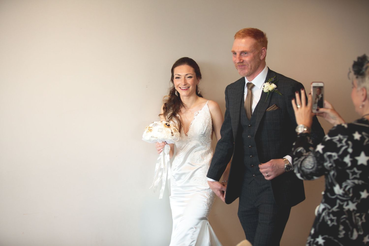 Wedding couple makes grand entrance at reception venue.