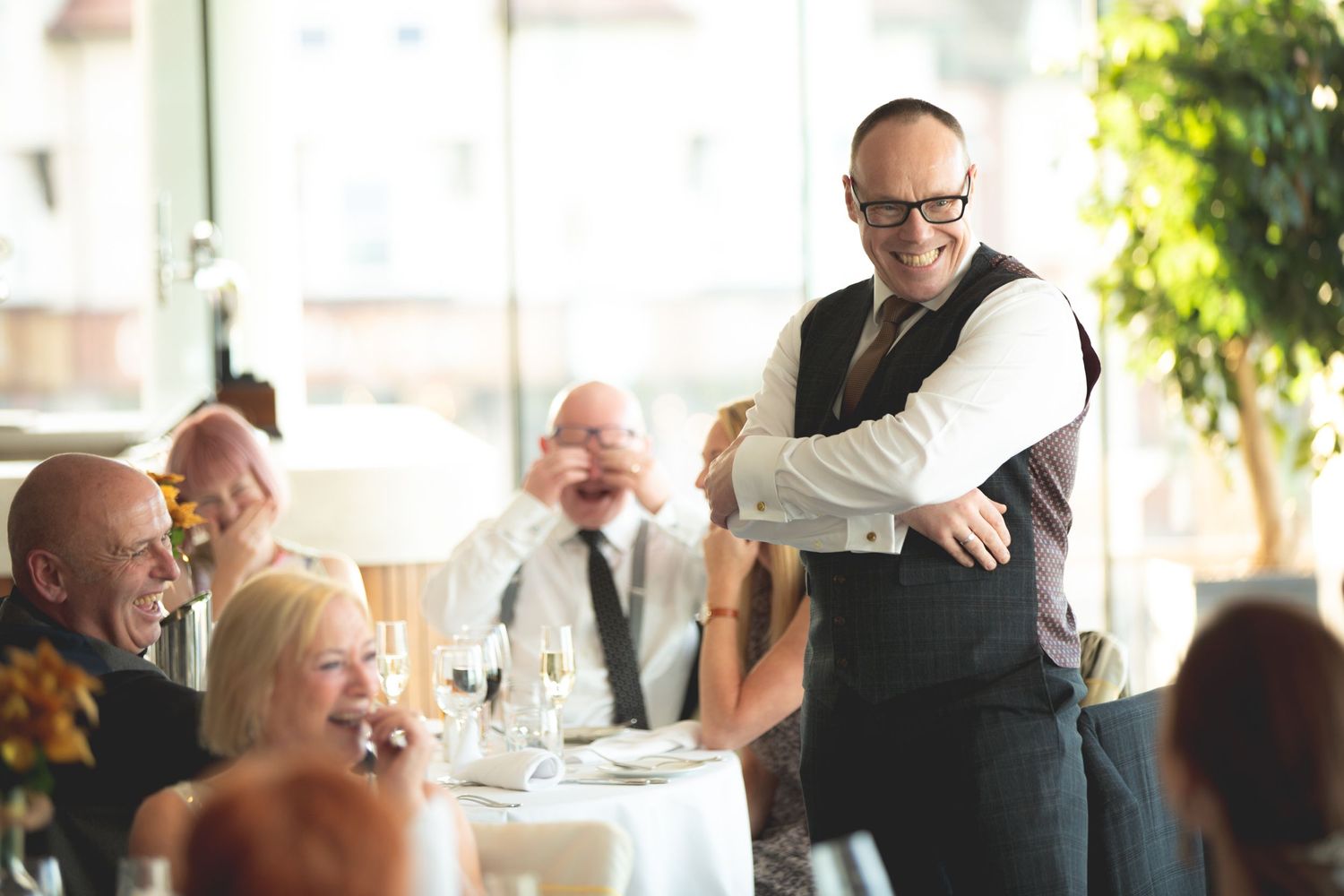 Professional server engaging with dinner guests during an upscale dining event.