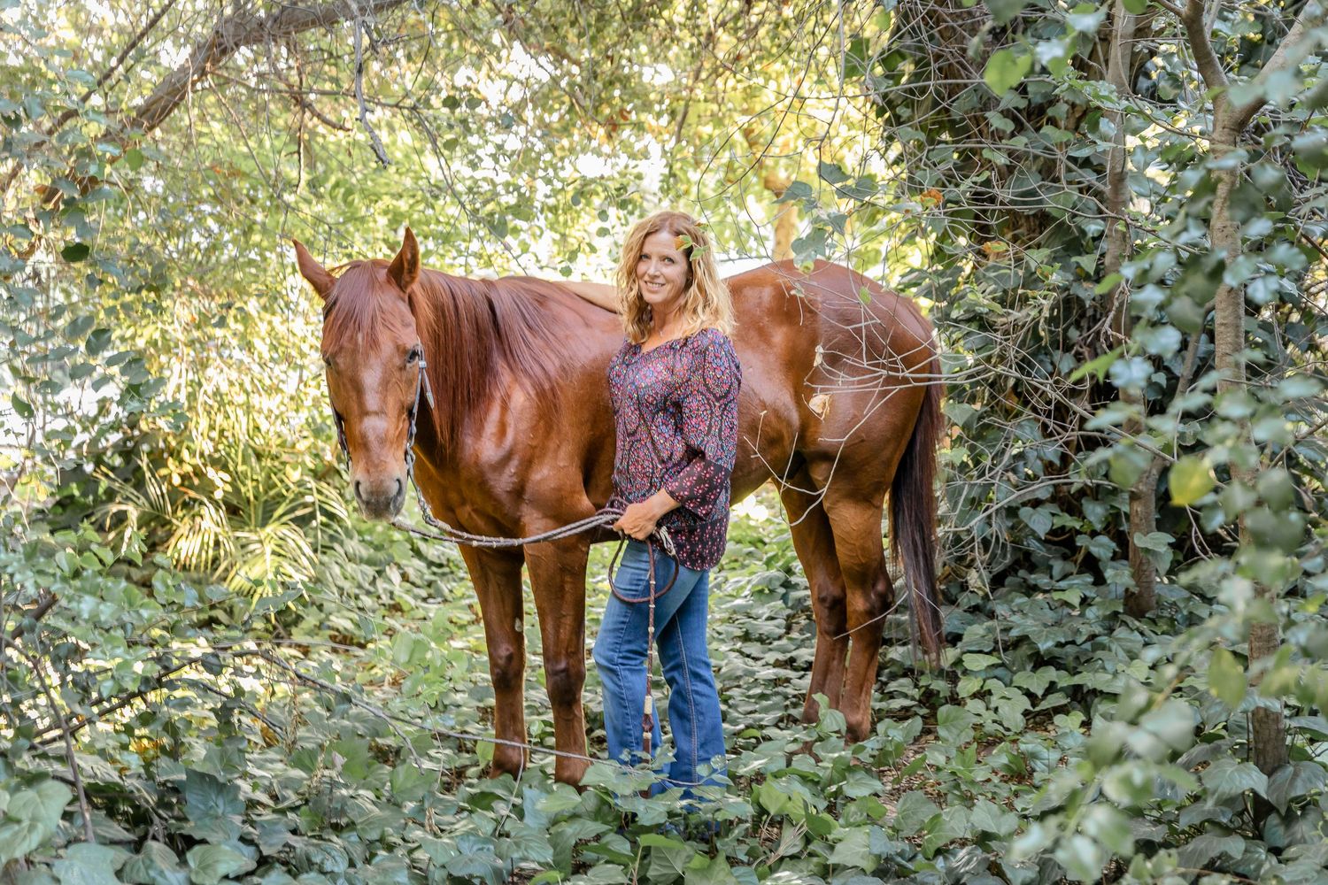 Red headed pony and his owner in the ivy