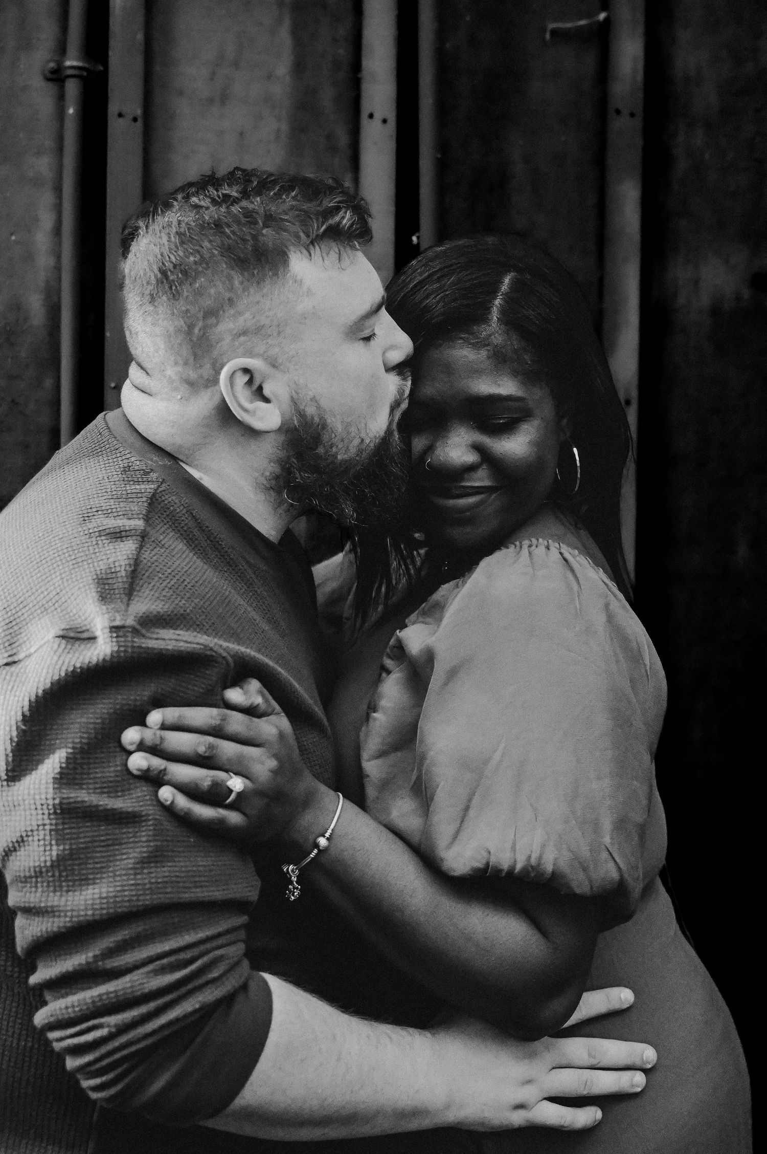 Black and white photos capturing intimate embraces and emotional moments between two people.