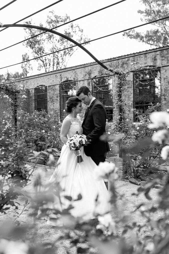 Standing amongst the roses at Lace on Timber, Jaco and Simone shares a moment on their wedding day.