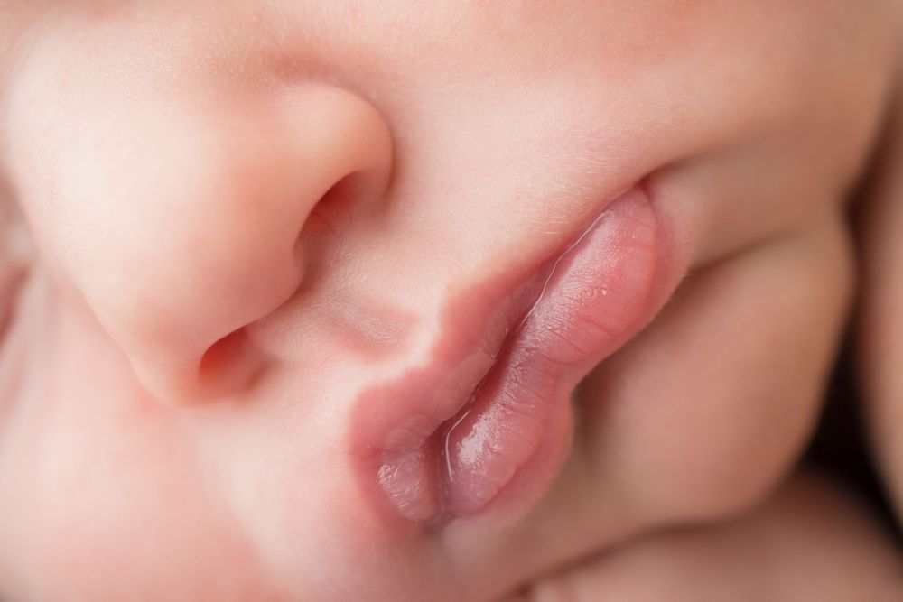 Extreme close up macro photo of baby's lips and nose showing delicate details.