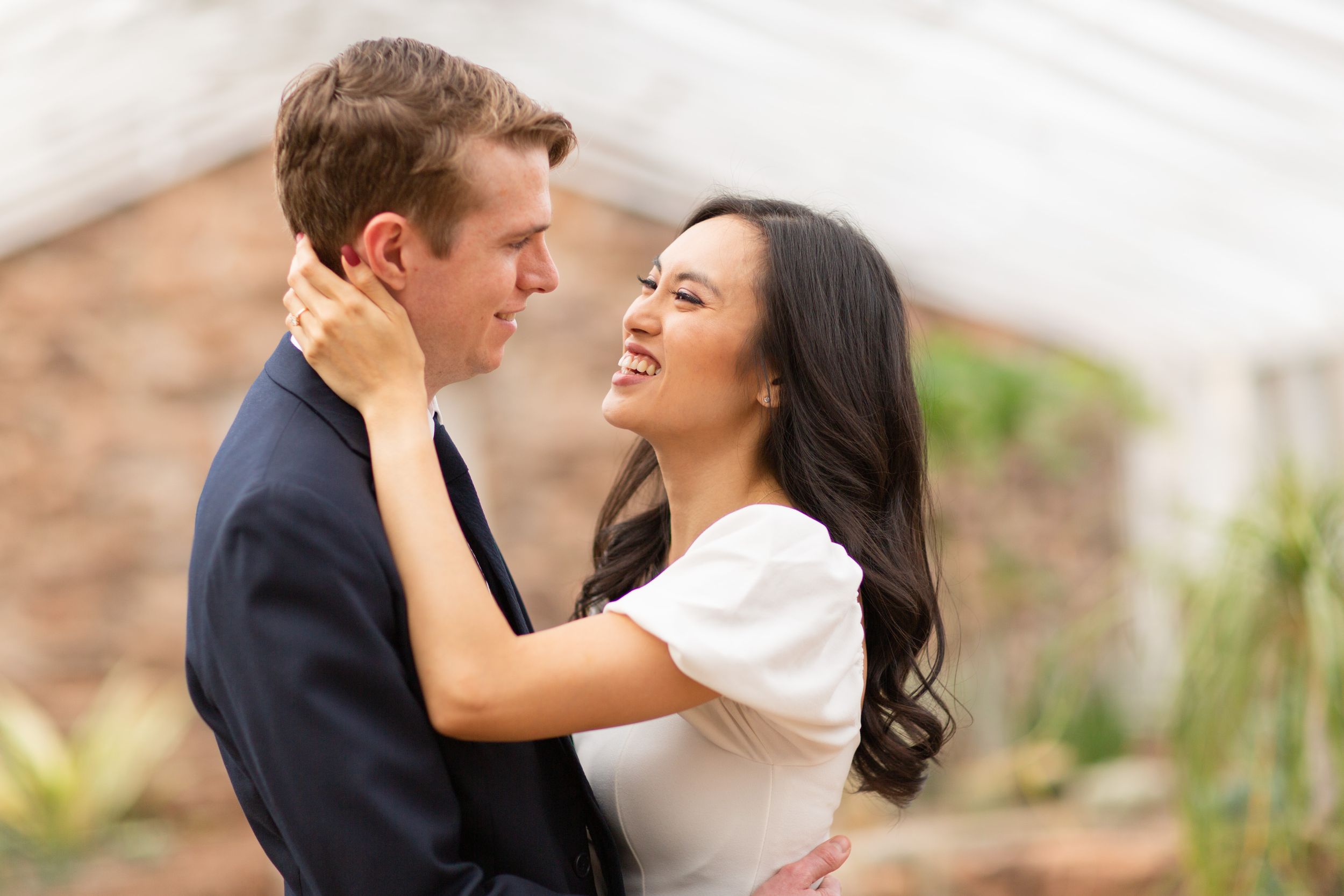 A tender embrace captured in soft natural light against a desert backdrop.