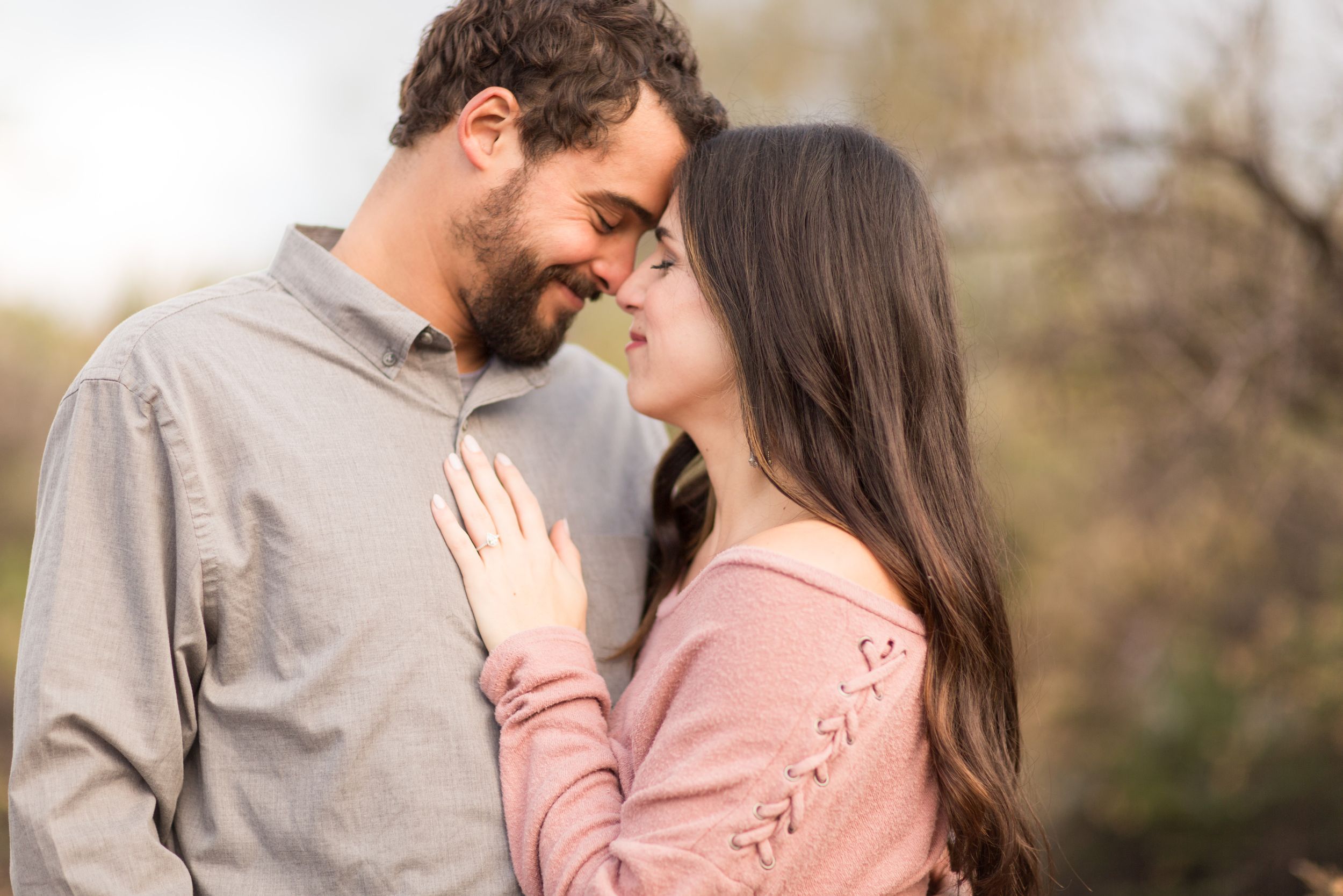 A tender moment between a couple during an outdoor portrait session.