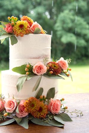 Two Tier wedding cake at a summer wedding in the rain.