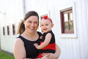 Mother holding her one year old daughter for her one year milestone session.  Mommy and Me