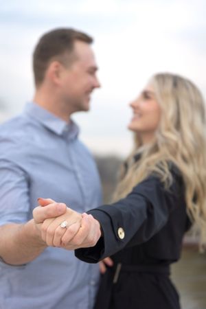 Showing off the new engagement ring after their surprise proposal photoshoot.
