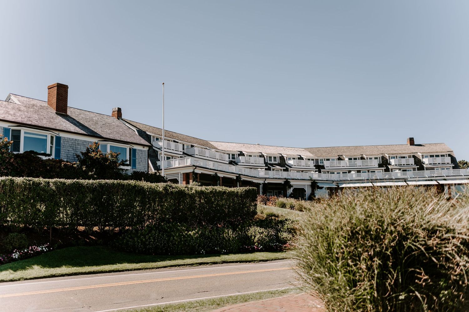 Row of coastal homes on a hillside overlooking the ocean.