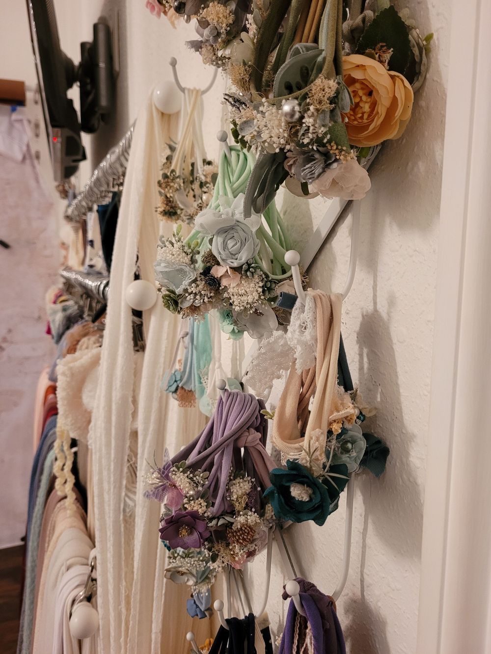 Dried floral arrangements and accessories displayed on a wall with vintage-inspired styling.