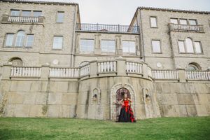 A panoramic view of a grand stone castle building with classic architectural features.