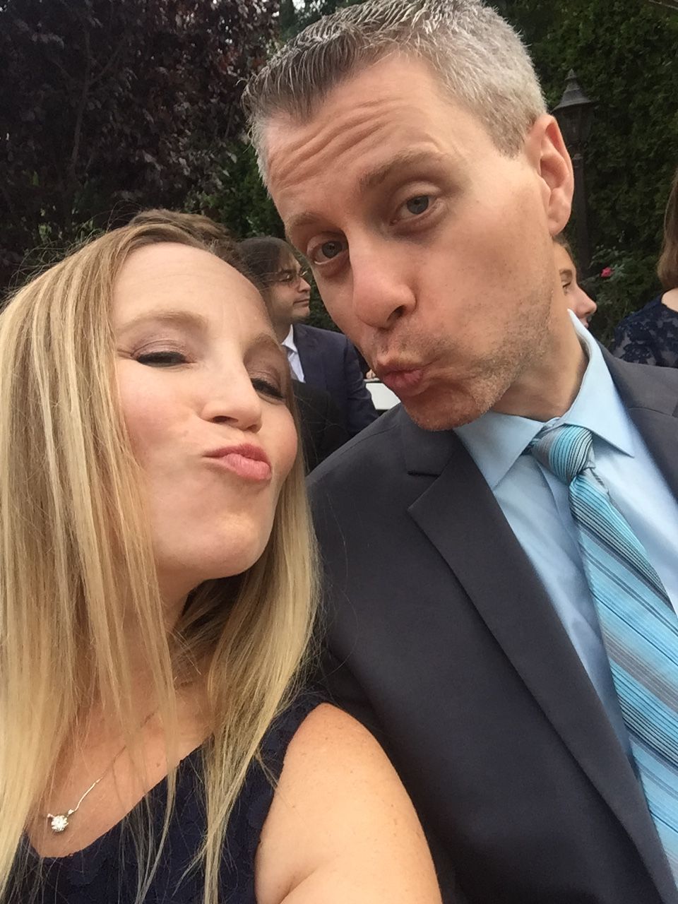 man and woman making funny face at a wedding