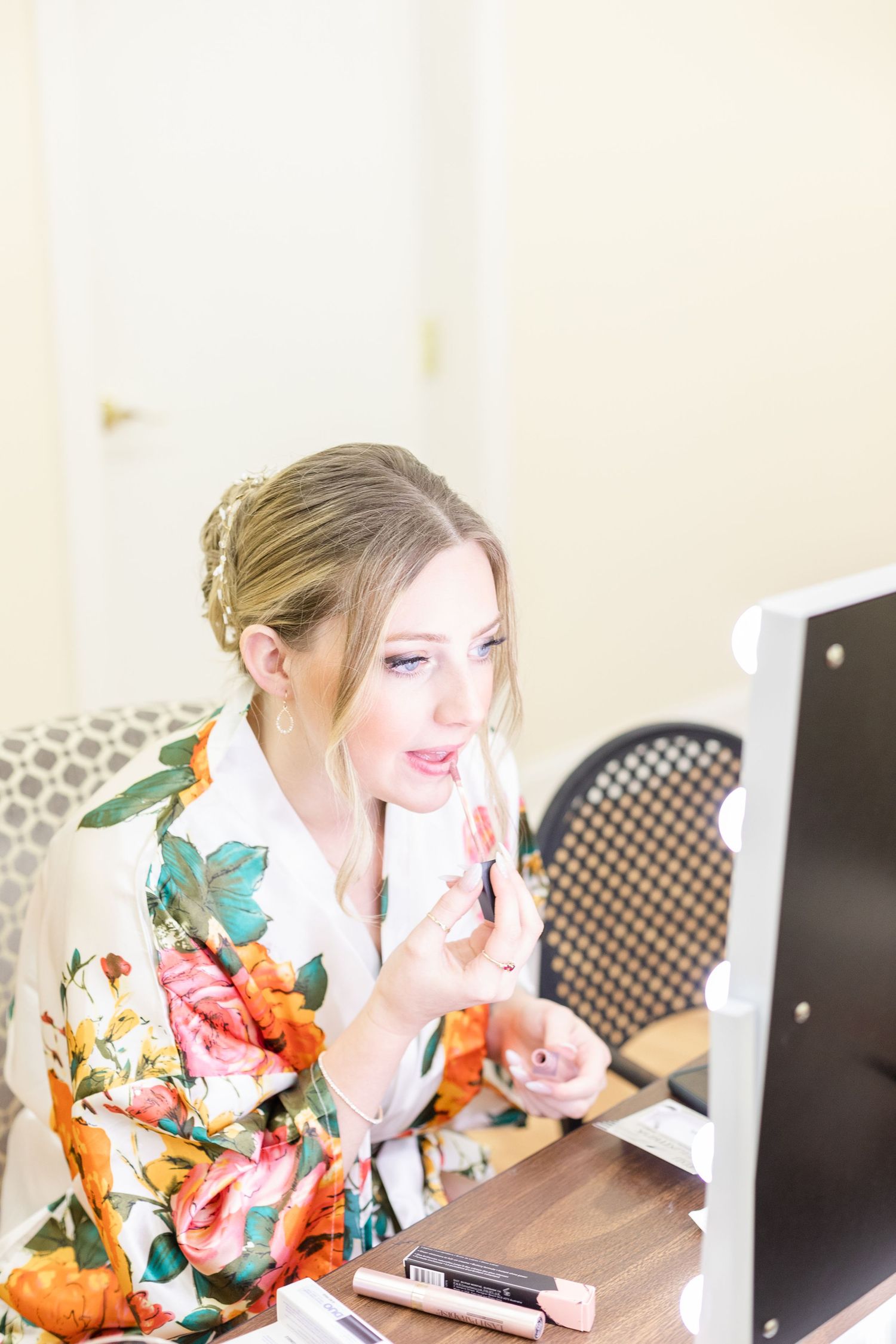 Floral robes and makeup preparations in a bright dressing room setting.