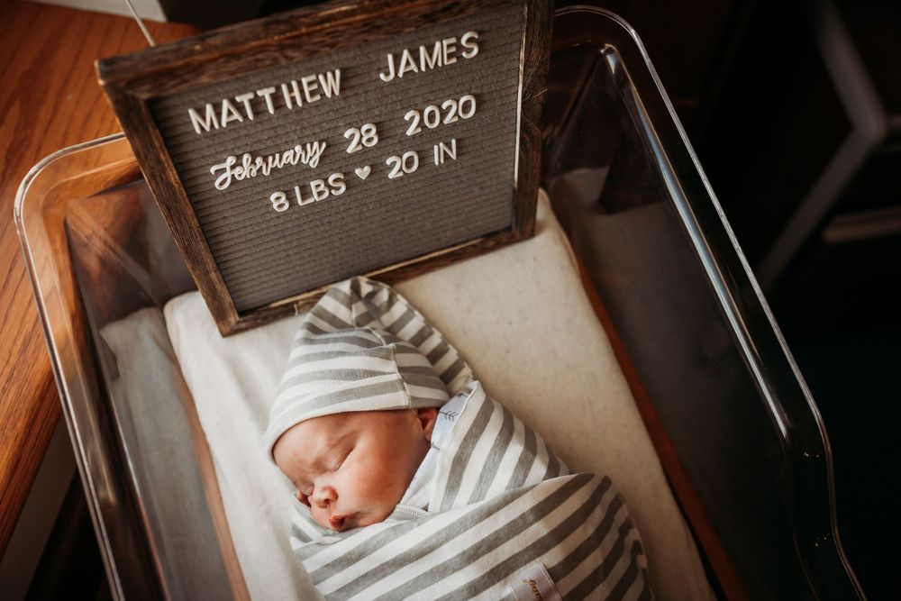 Sleeping newborn Matthew James born February 28 2020 8 lbs 20 inches in bassinet.