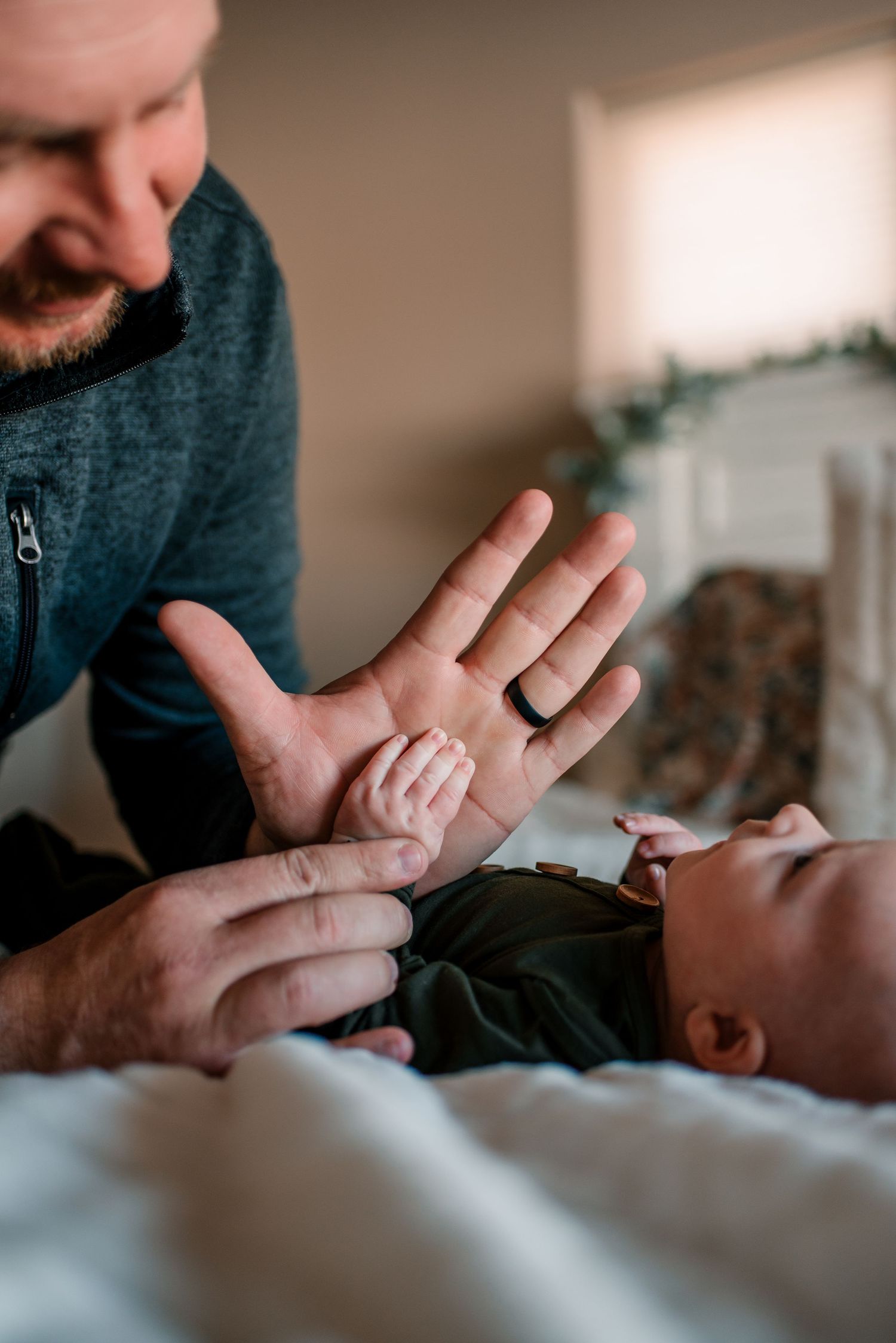 Close-up of gentle hands touching during an intimate family moment.