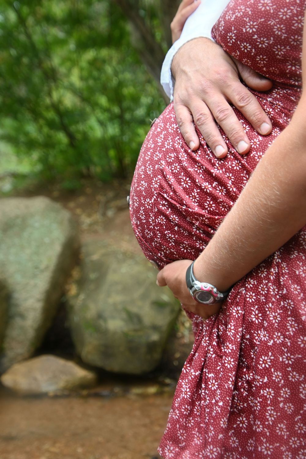 Close up details of a floral print dress in burgundy with delicate white pattern.