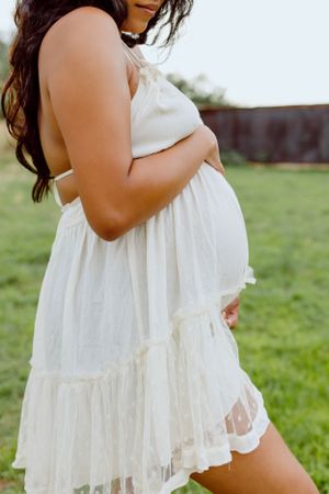 A flowing white lace dress photographed in a desert ranch setting.