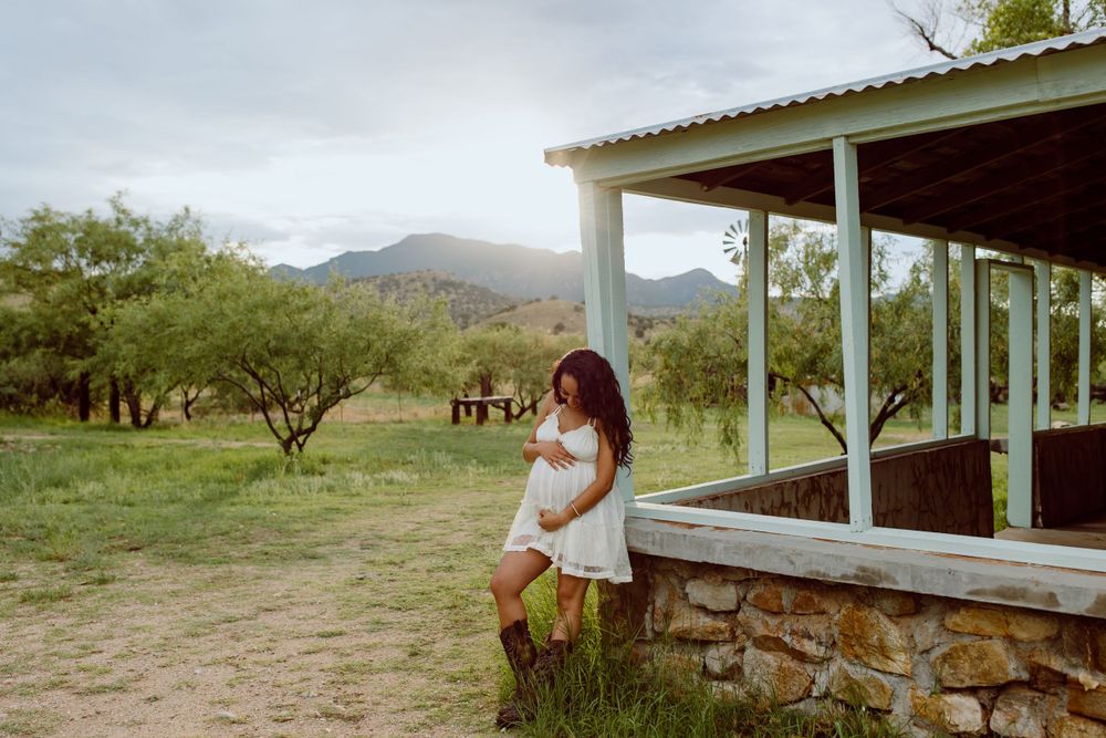 A peaceful desert scene with mountains and a covered porch in soft lighting.