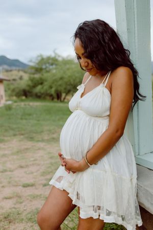 A white lace dress against a rustic porch backdrop in desert scenery.