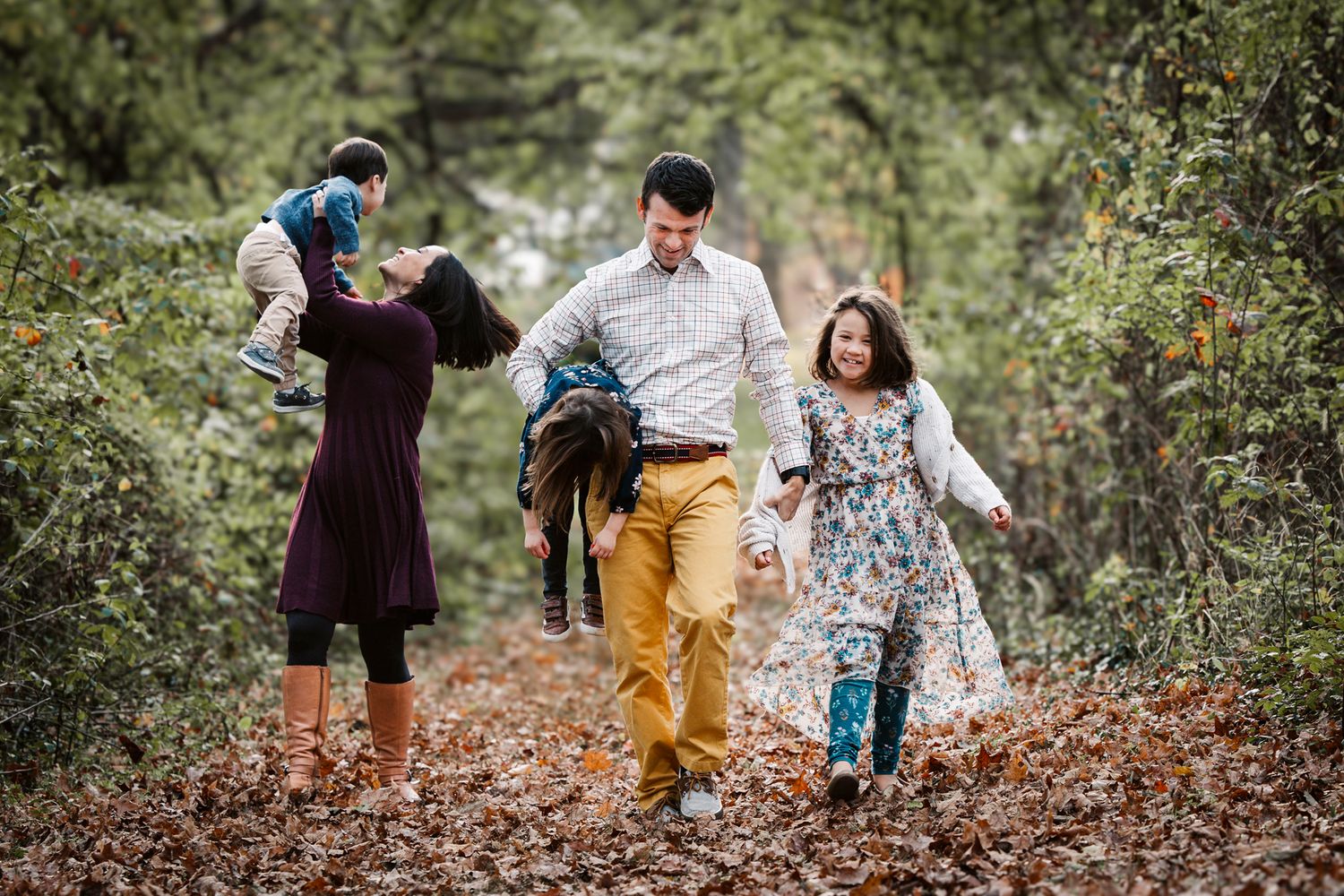 The Walker family strolls through the Alms Park woods for their portrait session with Stephanie Buechler, Photographer.
