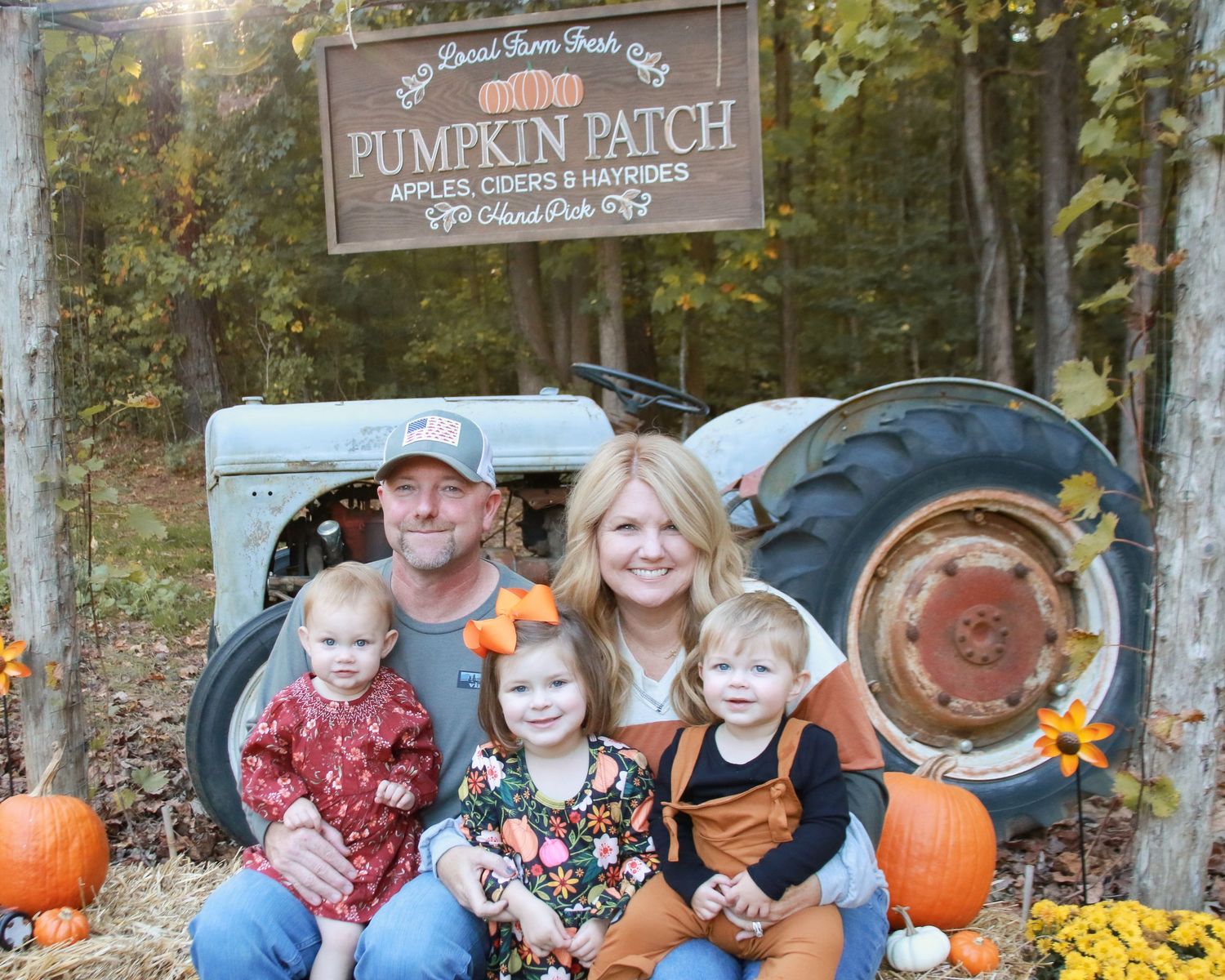 Rustic pumpkin patch setting with hay bales and autumn decorations.