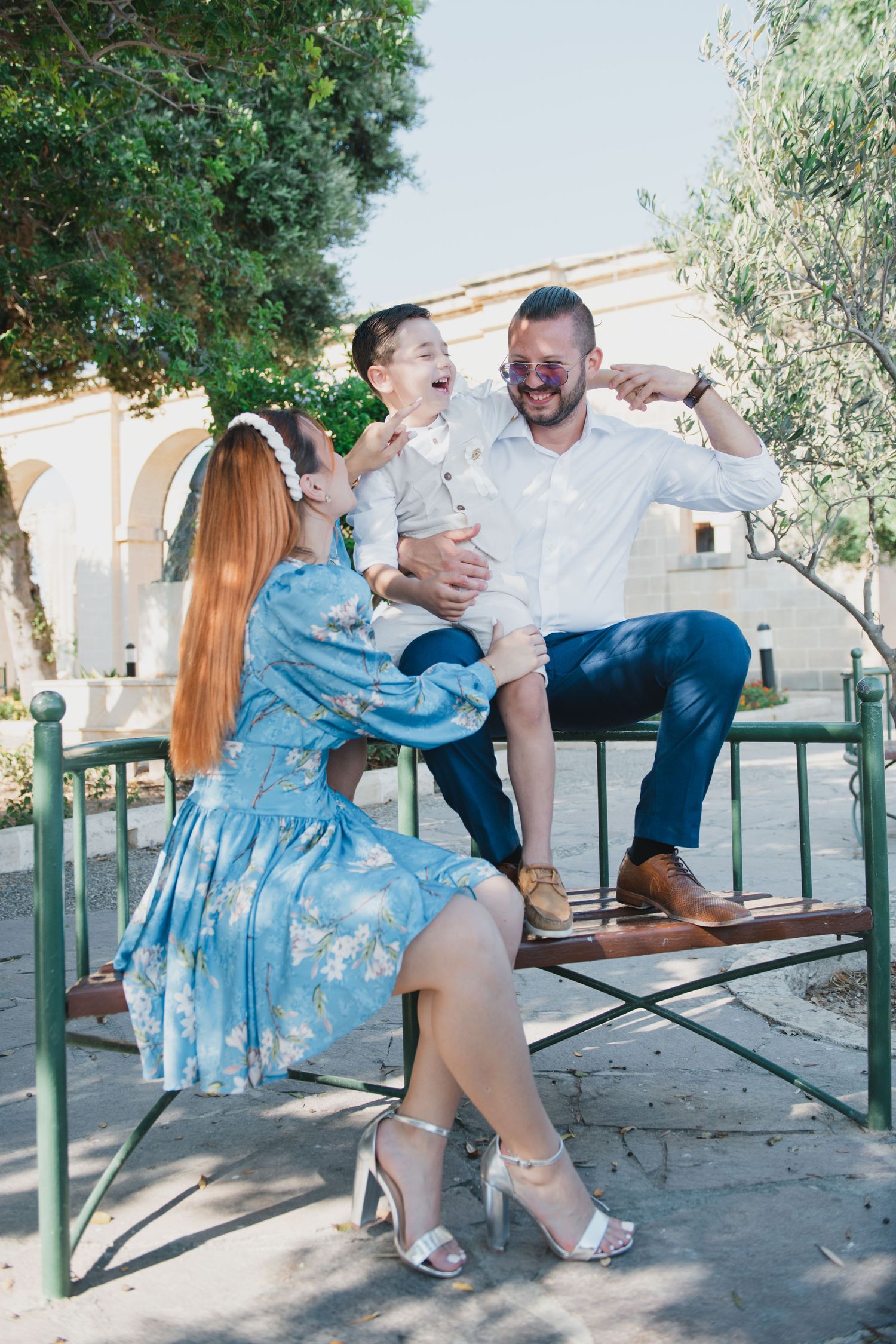 Candid family moments on a park bench showing laughter and joy.
