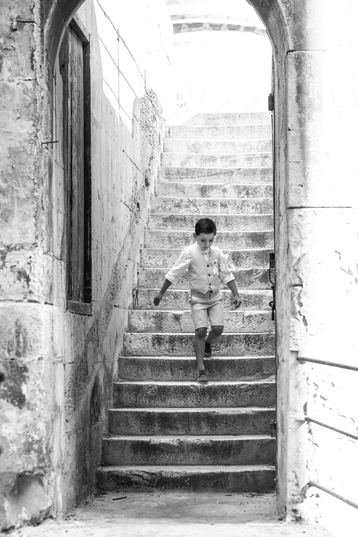 Black and white architectural photo series featuring stone archways and steps.