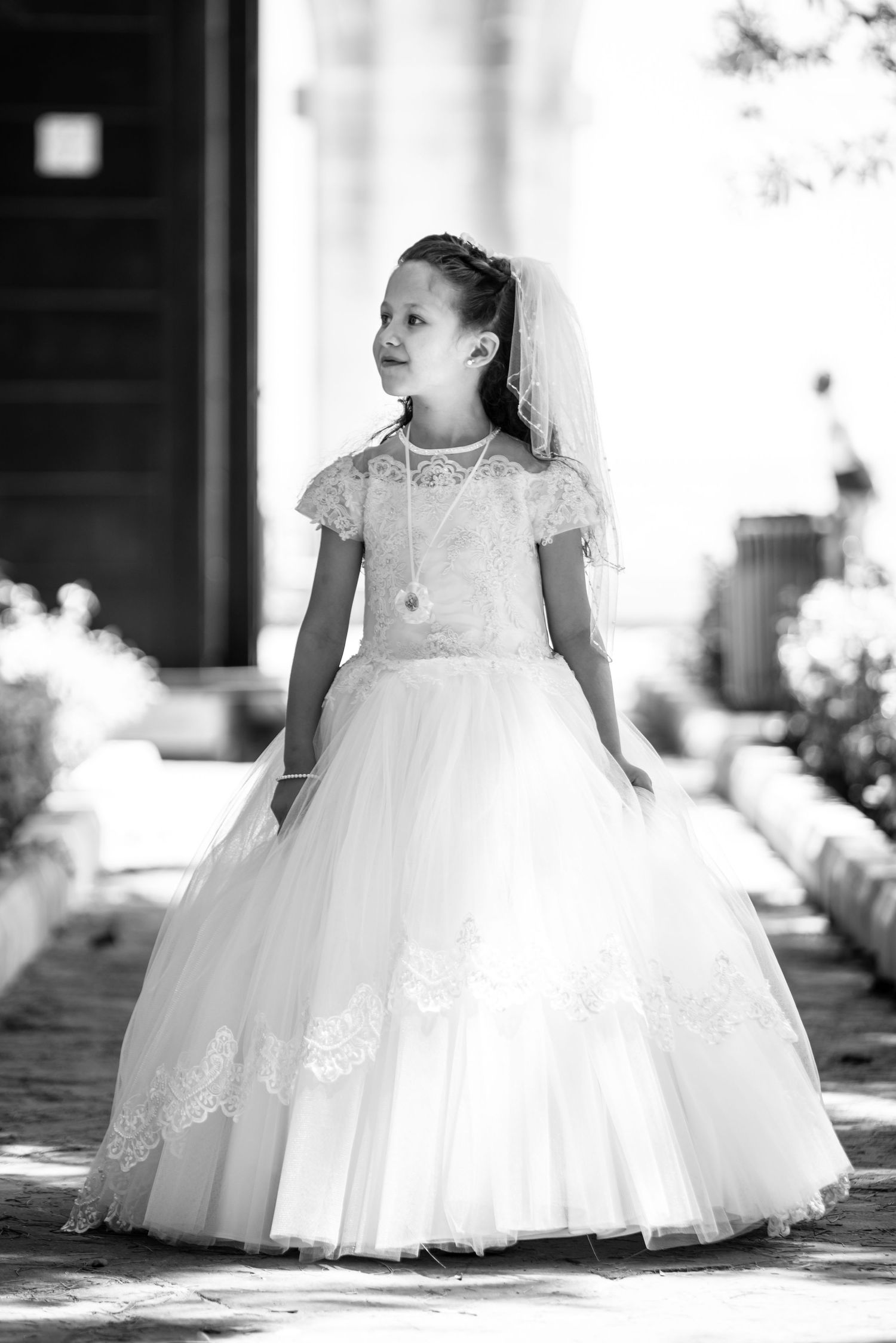 Black and white portraits showcasing a flowing white gown with intricate lace detailing.