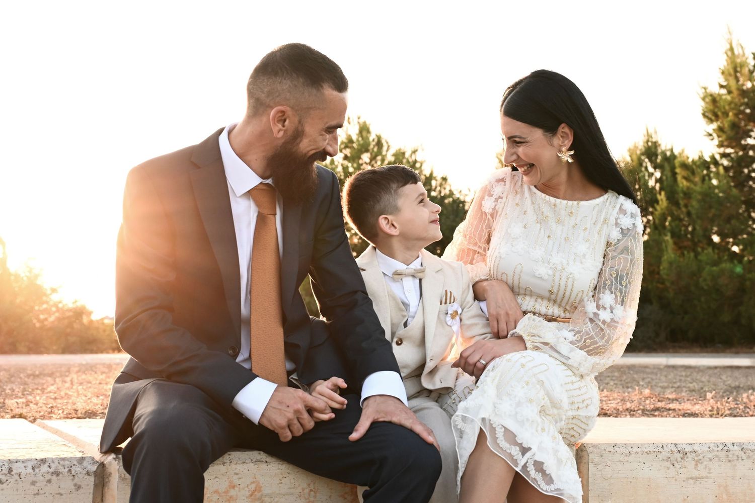 Sunset family photo session with formal attire outdoors.