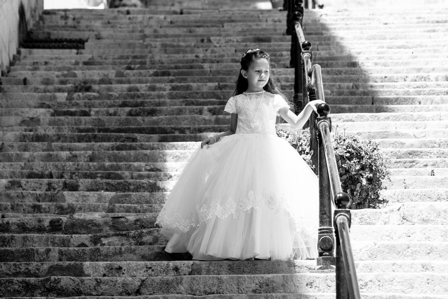 Multiple views of an elegant white dress photographed against historic brick architecture.