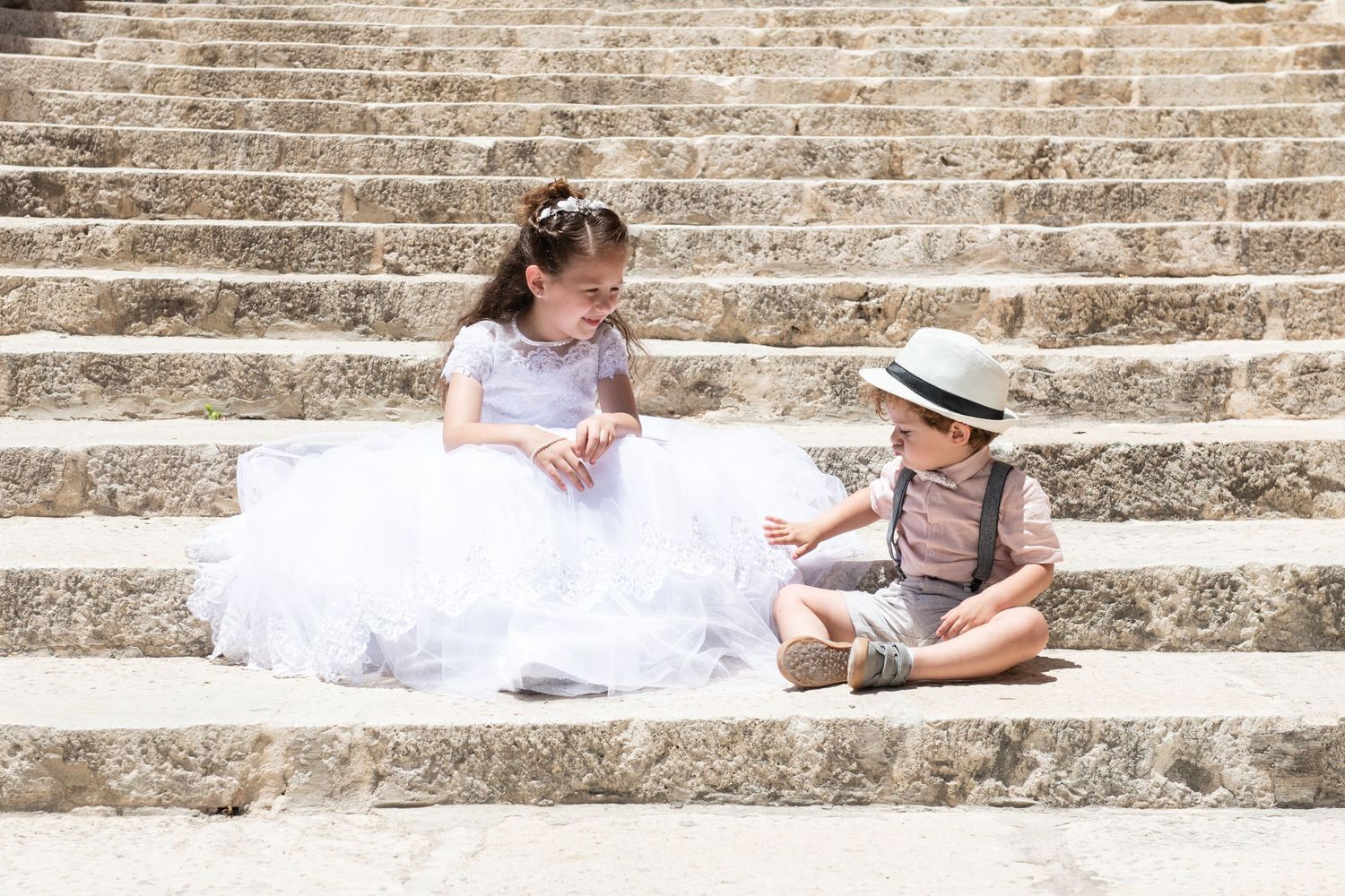 A flowing white dress captured in multiple frames along rustic stone steps.