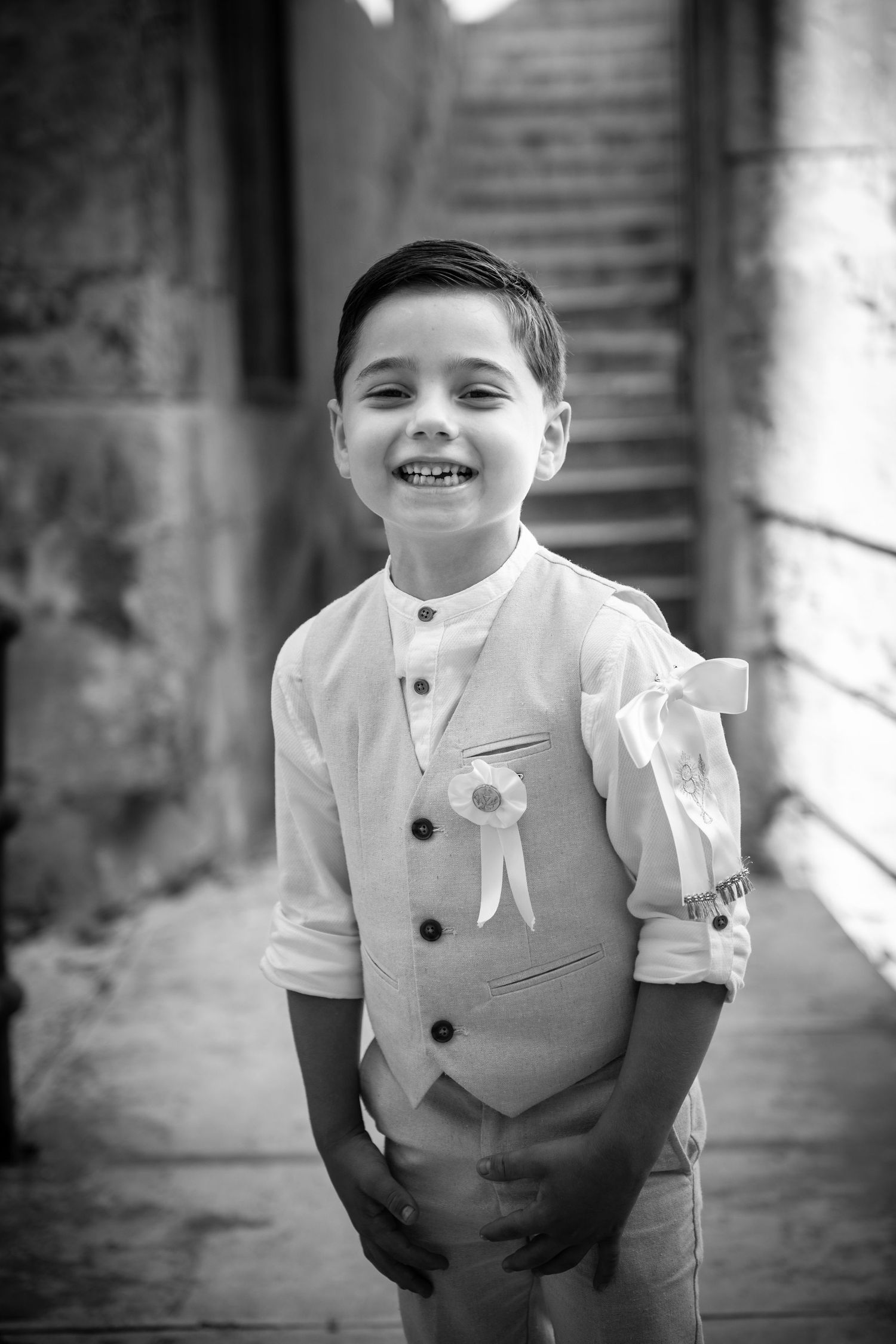 Black and white portrait series showing cheerful expressions in formal wear.
