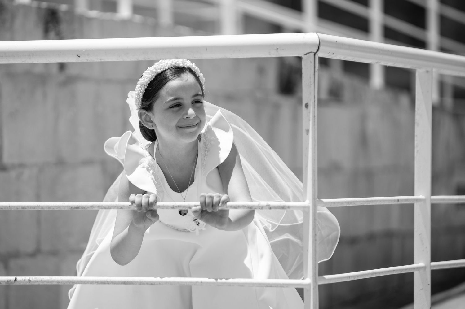 A sequence of joyful poses against a metal railing outdoors.