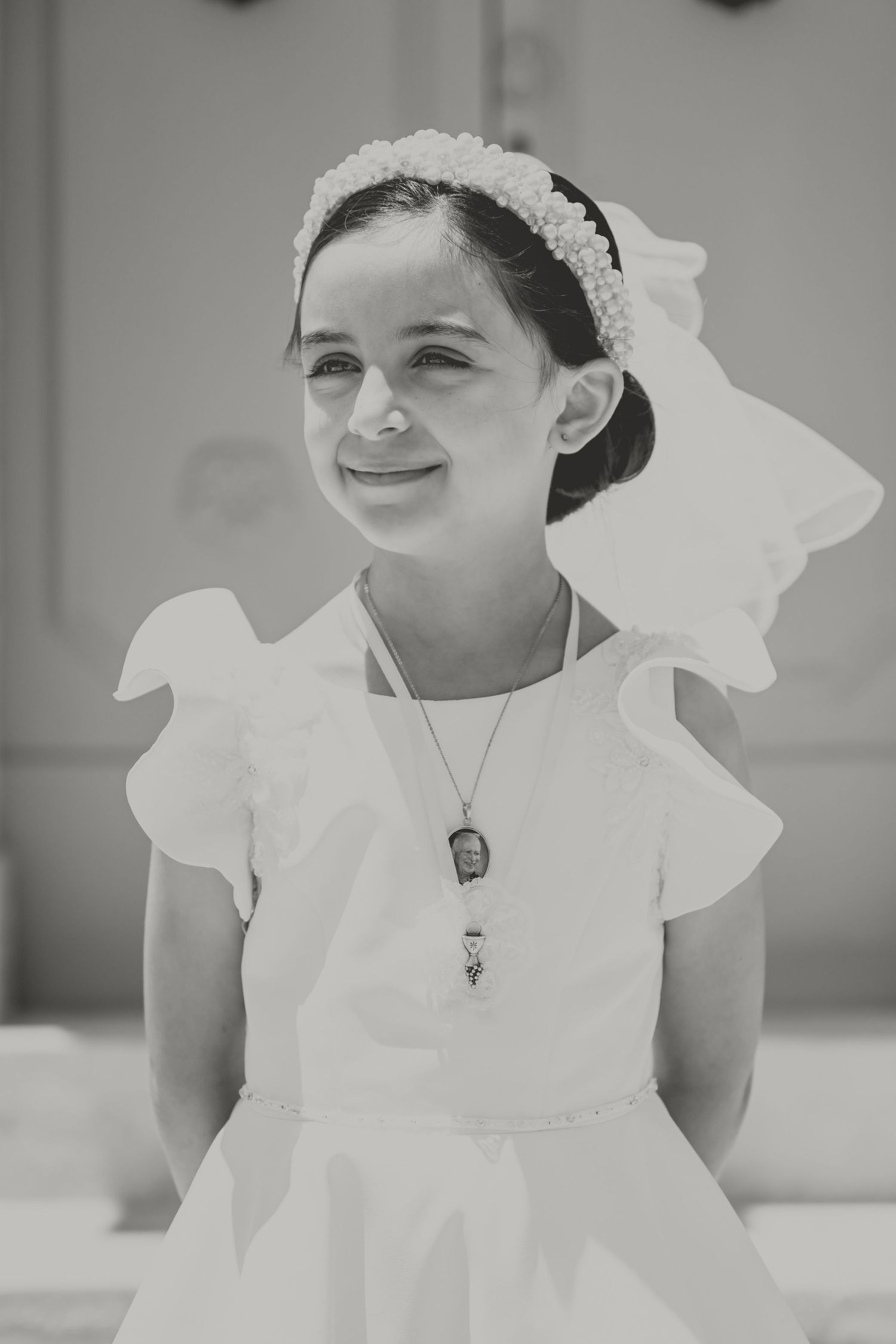 Black and white portraits showing joyful expressions in a white dress and headpiece.