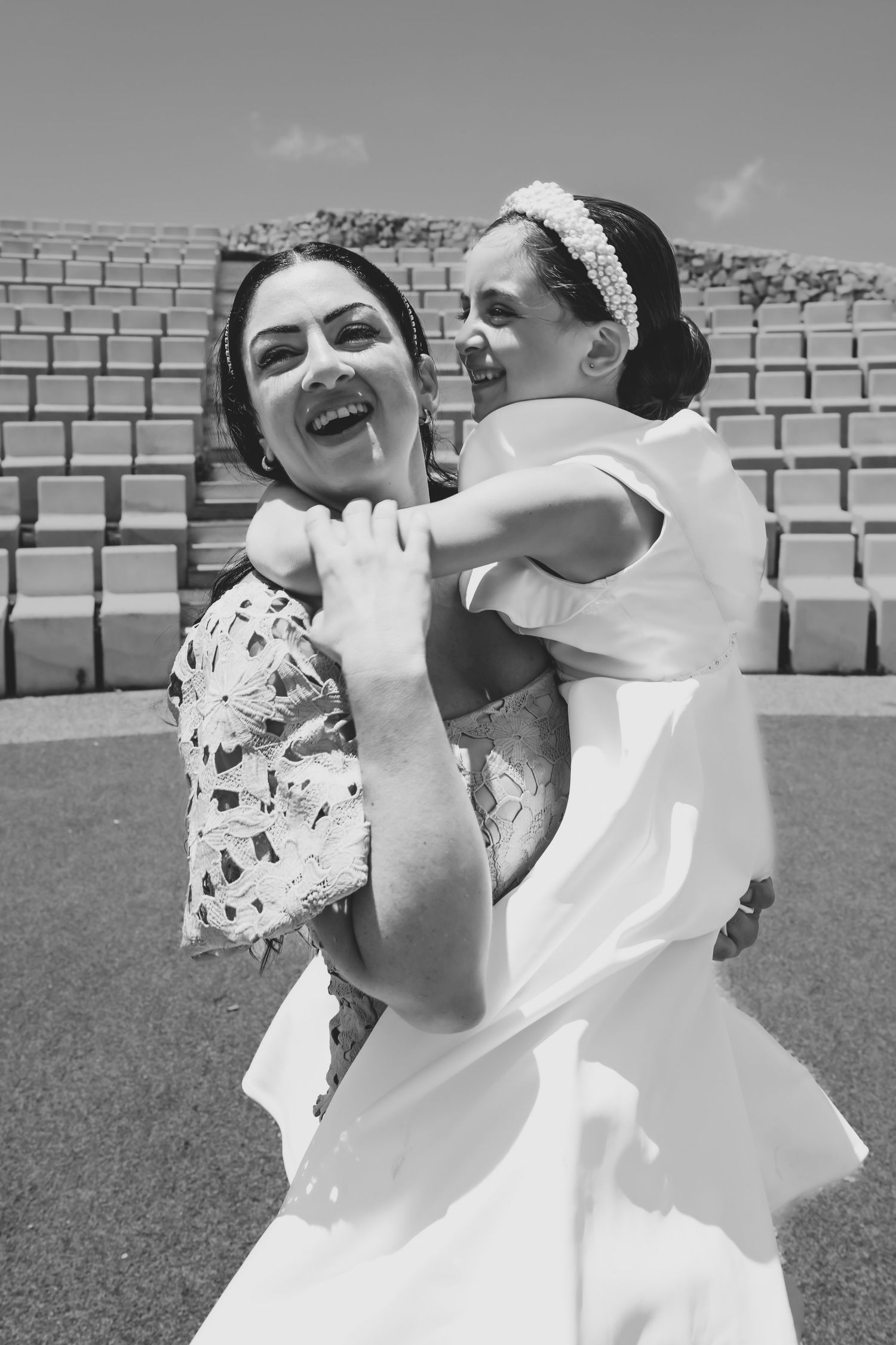 Playful black and white photo sequence showing energetic movements in an outdoor stadium.