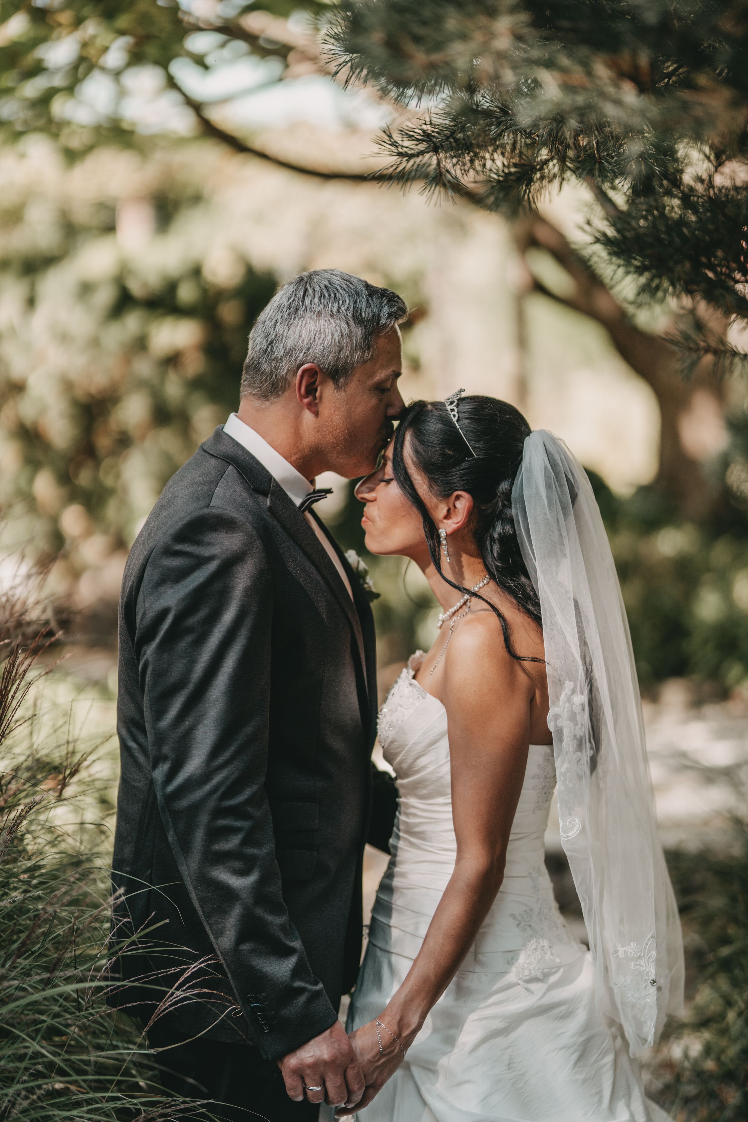 Romantic wedding portrait moment in outdoor garden setting.