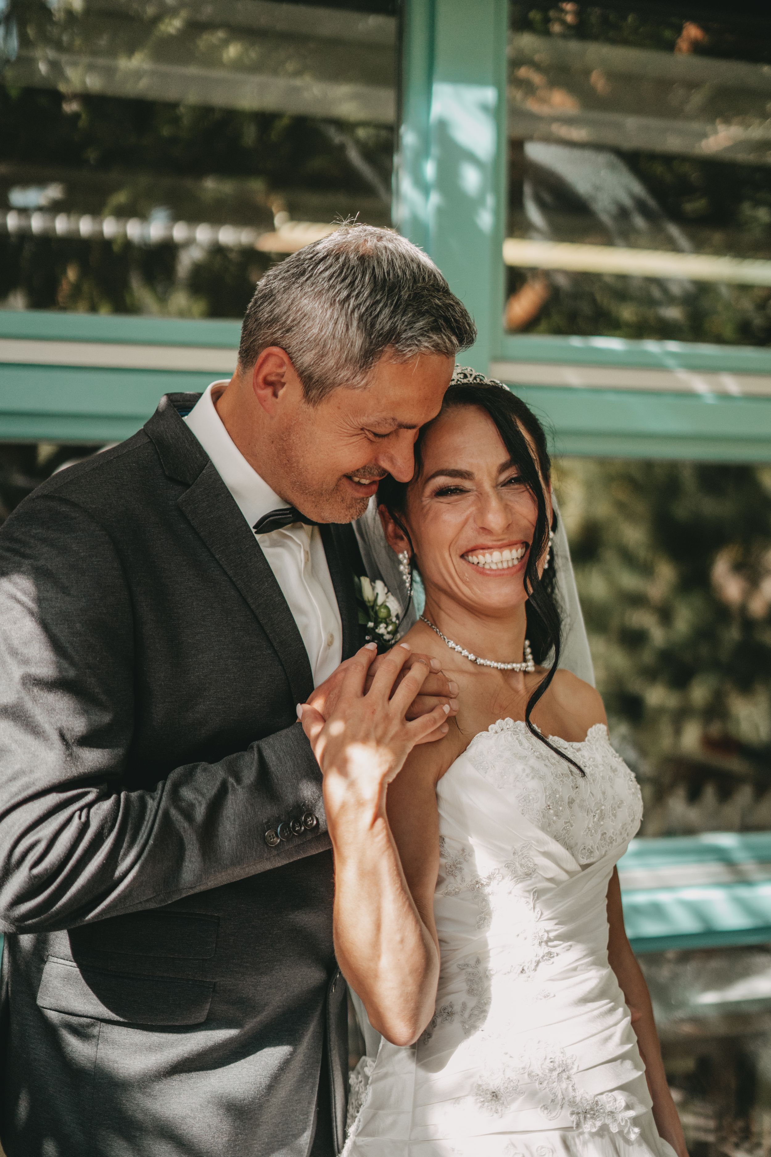 Candid wedding sequence showing joyful laughter between newlyweds outdoors.