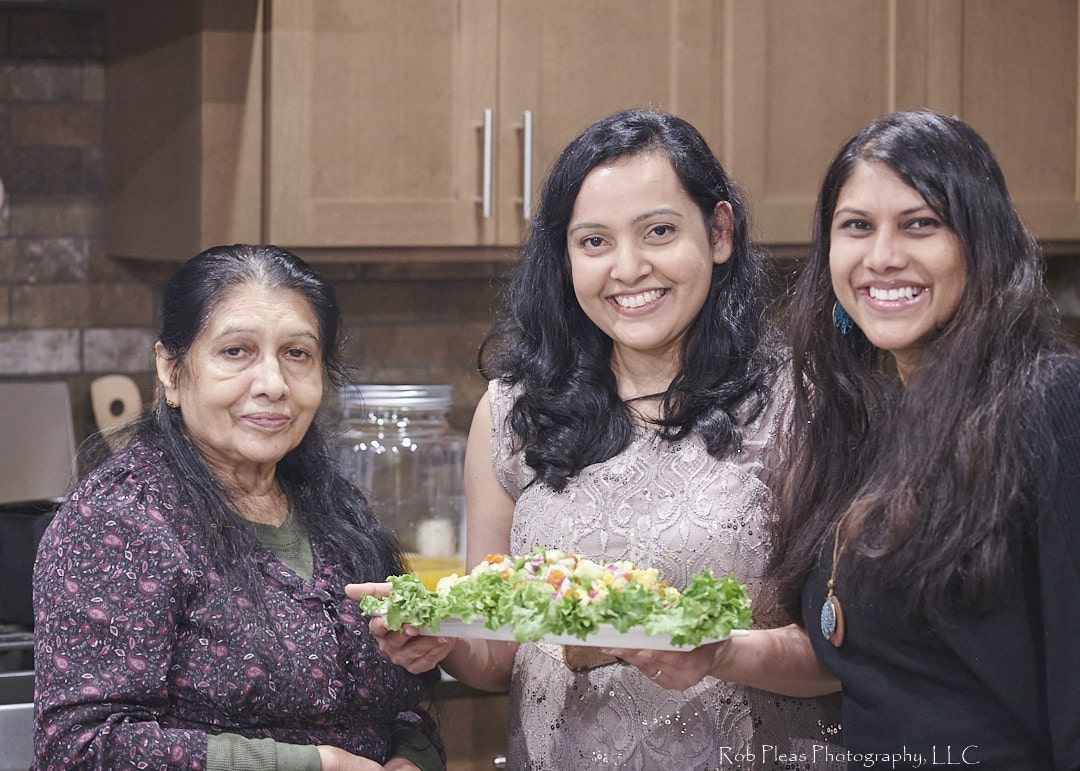 first birthday mom, grandma, and sister holding salad in kitchen