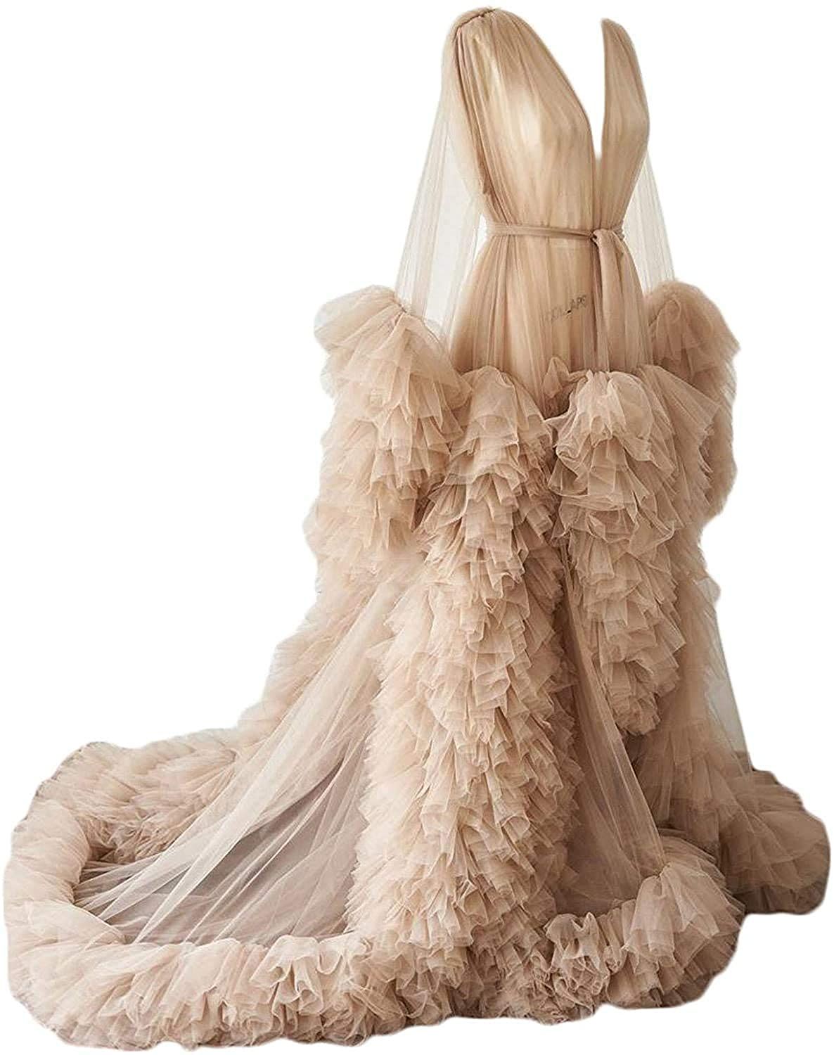 Elegant champagne-colored tulle gown with dramatic ruffles photographed against white background.