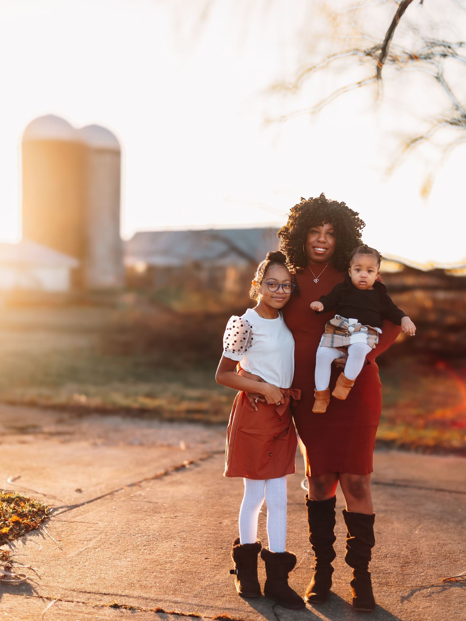 Children in coordinating outfits playing together during golden hour sunset.