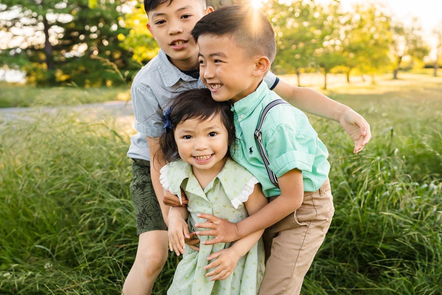 Siblings hugging each other at sunset