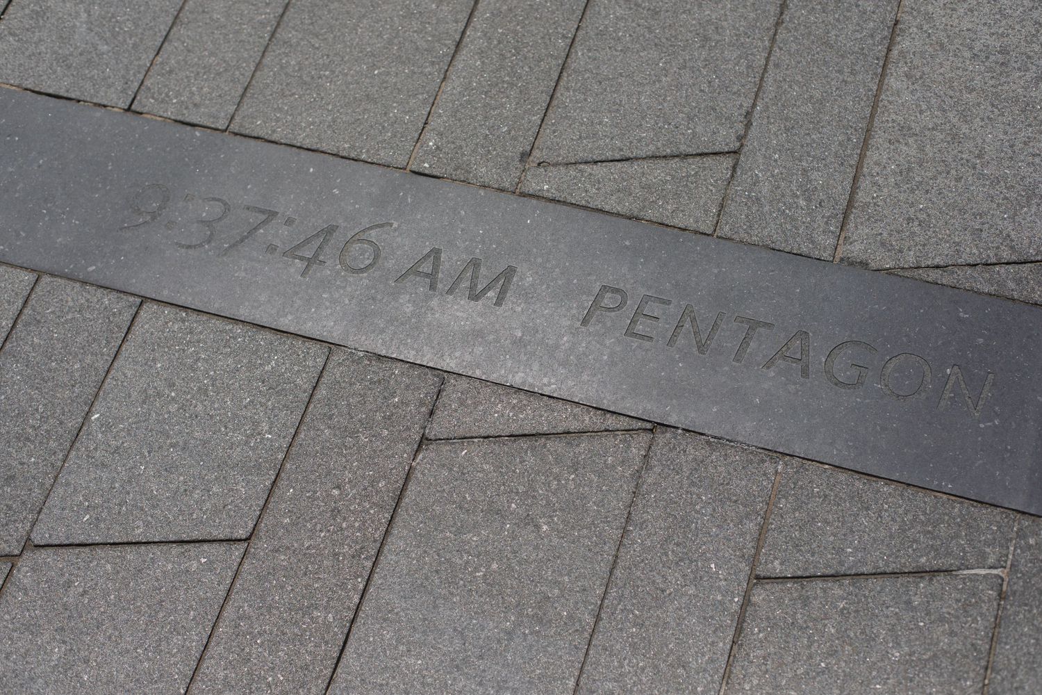 Stone memorial inscription showing Pentagon attack timeline details.