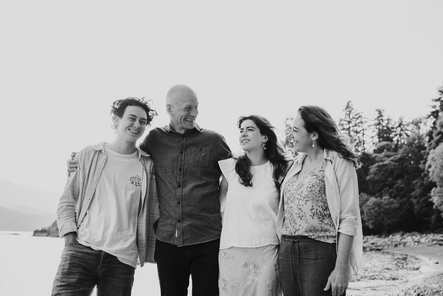 Family of four with teenagers hugging at Whitecliff Park in West Vancouver.