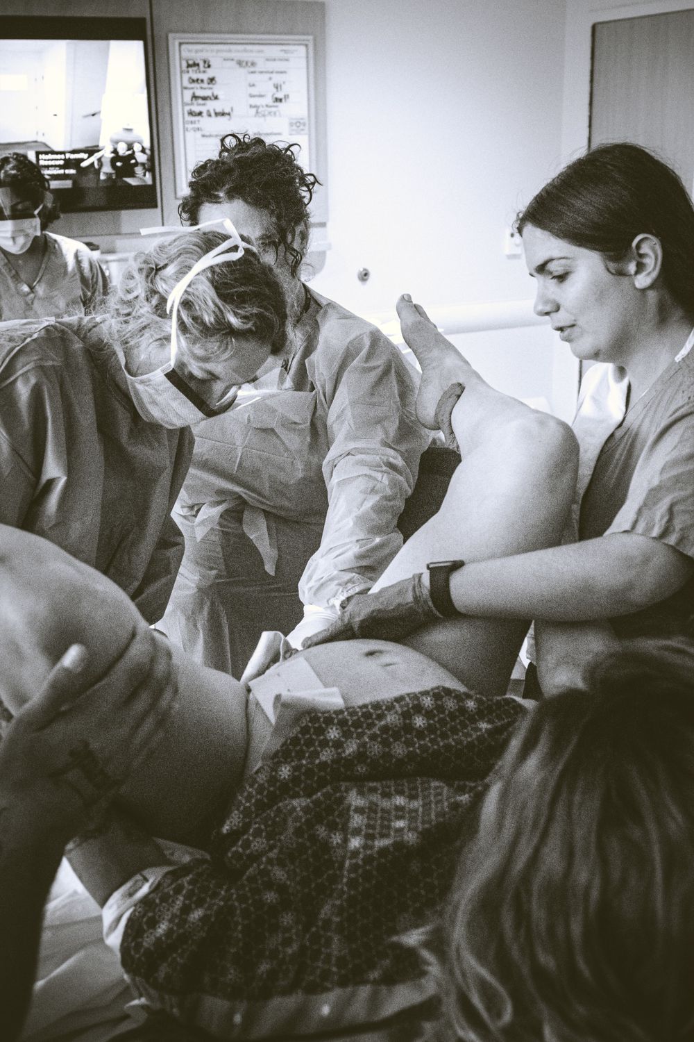 Medical team providing care in a clinical setting with hospital equipment visible.